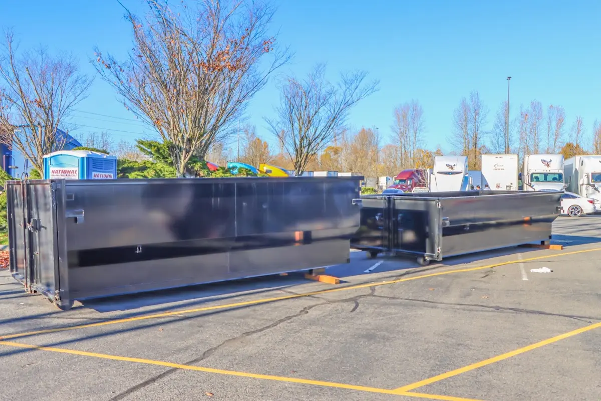 Professional dumpster rental service with roll-off container on residential driveway in East Whiteland